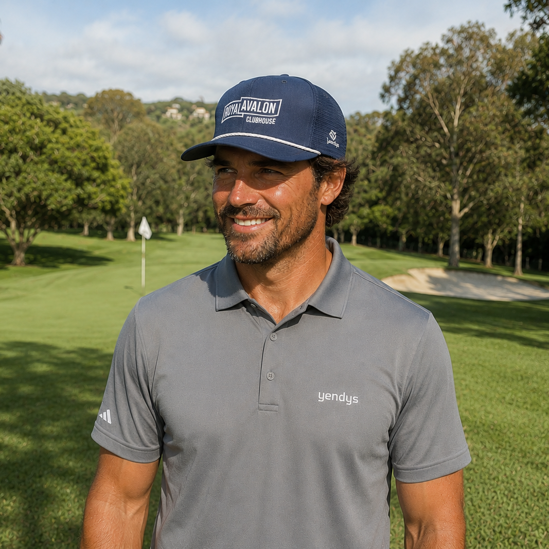 Man wearing a cap and gray polo shirt on a golf course